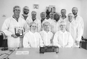 Spire team with one of their satellites / Image courtesy of Spire