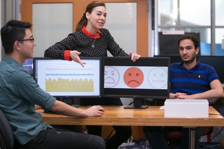 professor-dina-katabi-middle-explains-how-phd-fadel-adibs-face-right-is-neutral-but-that-eq-radios-analysis-of-his-heartbeat-and-breathing-show-that-he-is-sad-credit-jason-dorfman-mit-csail