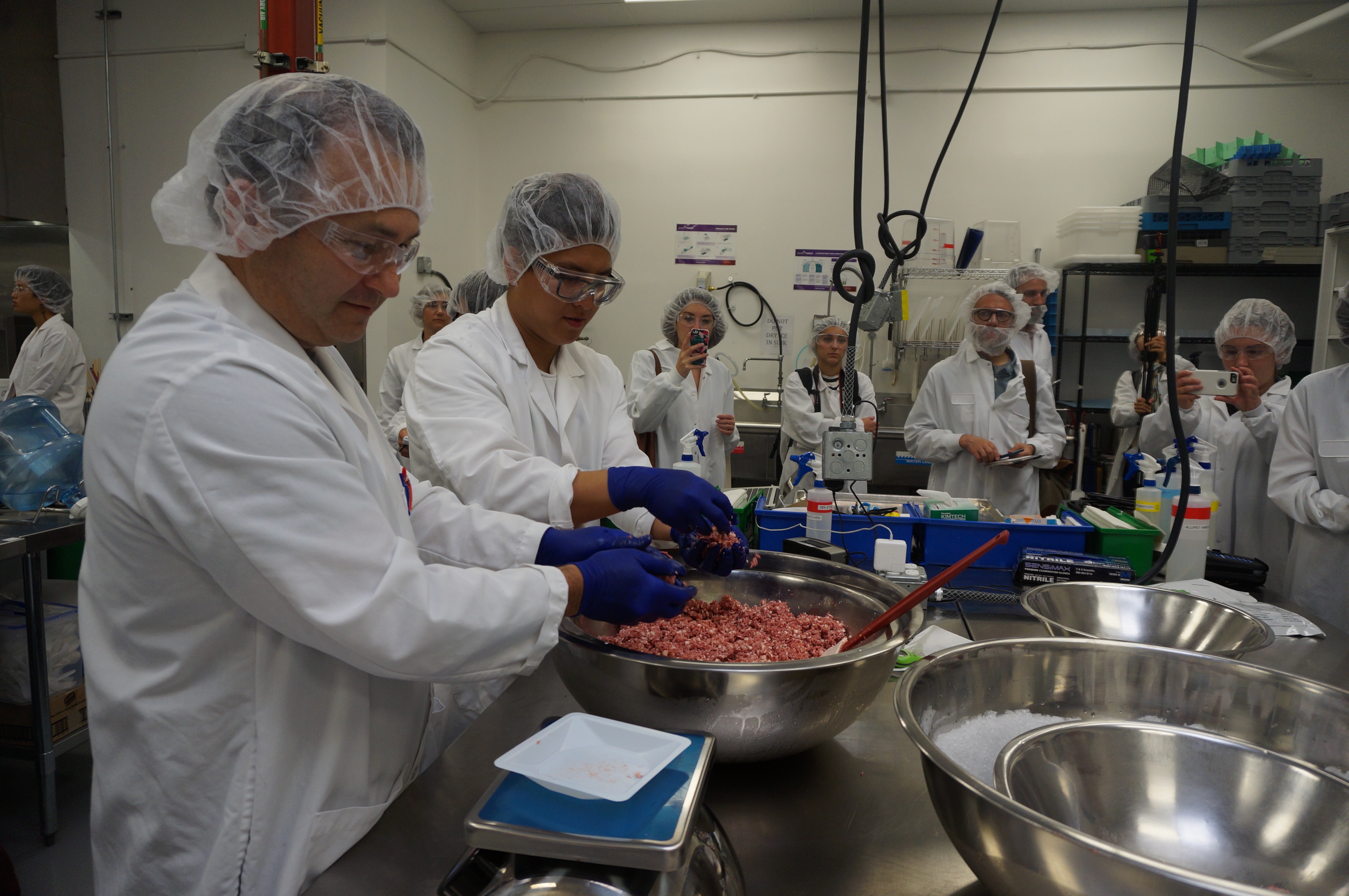 Lab workers at Impossible Foods test the plant-based burger.