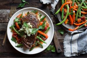 A Sun Basket meal: steaks with artichoke butter, green beans and bell peppers.