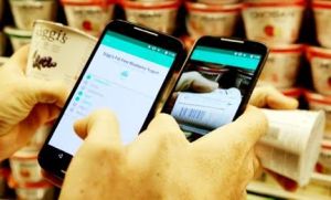 A HowGood users scans the barcode on a yogurt to learn its sustainability rating.