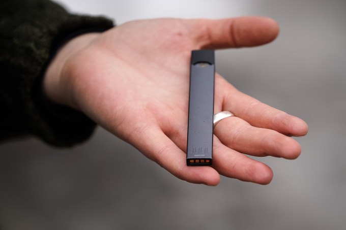 Woman holding Juul e-cig Woman holding Juul e-cig