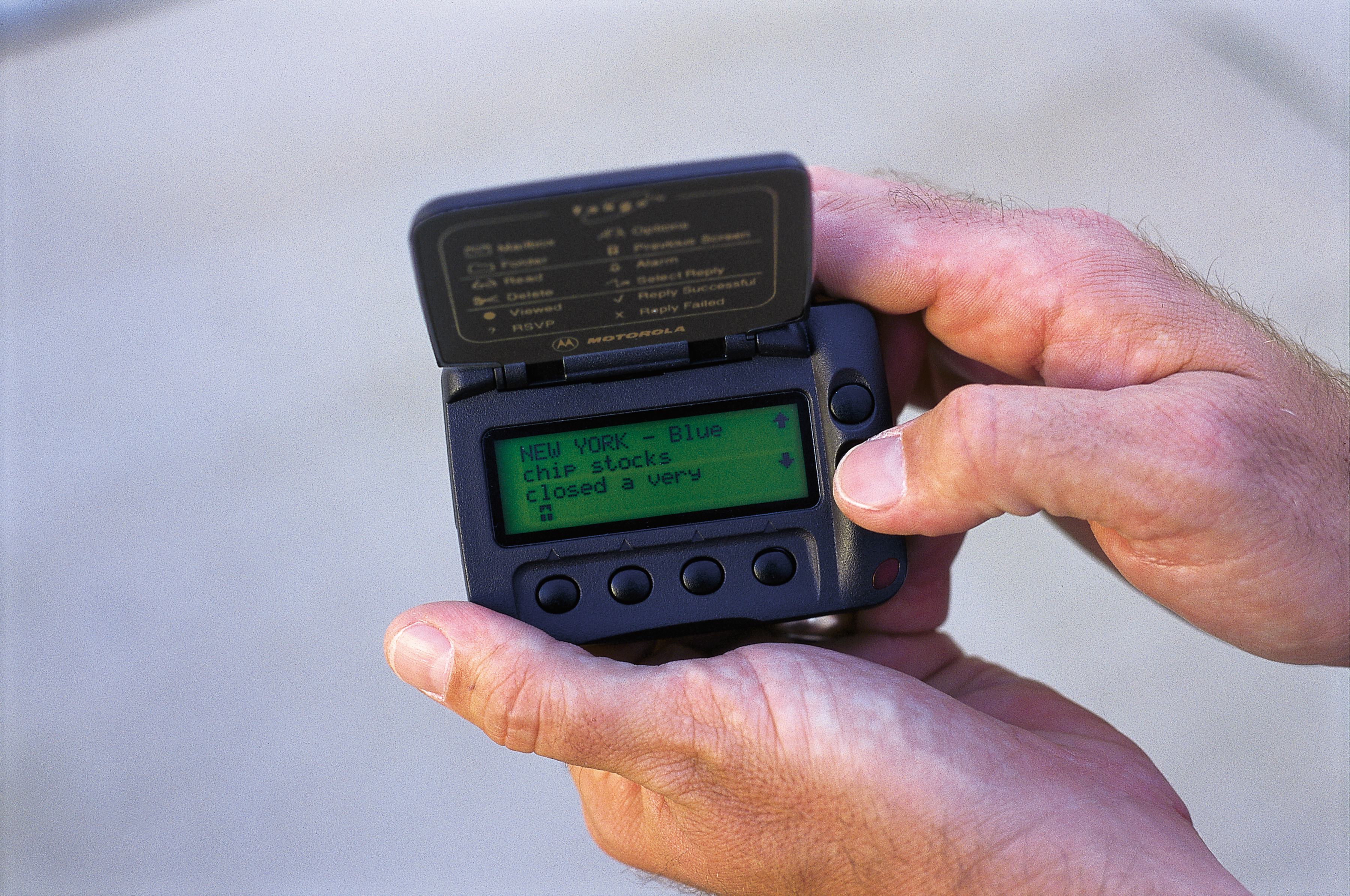 Hands holding alpha-numeric pager GettyImages 128243077